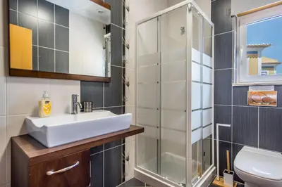 a bathroom with a sink and a shower at Villa Casa Vilas Boas in Albufeira