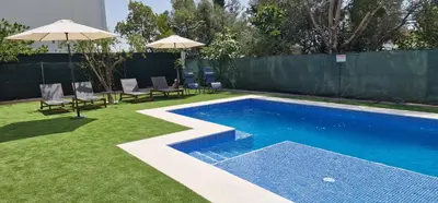 a swimming pool with a slide in a yard at Villa Pretty Stunning House with Garden and Private Swimming Pool in Almancil