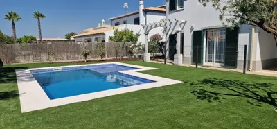 a swimming pool in a yard with green grass at Villa Pretty Stunning House with Garden and Private Swimming Pool in Almancil