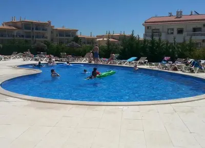 a group of people playing in a swimming pool at Vista das Ondas - Apartamento 204 in Albufeira