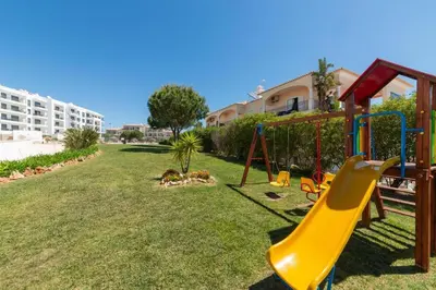a playground with a slide in a yard at Vista das Ondas - Apartamento 204 in Albufeira