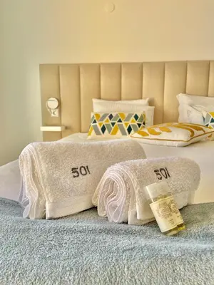 a bedroom with two beds with towels on them at F&V Studio Vilamoura in Quarteira
