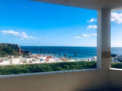 a view of the ocean from a window at Apartamento Varandas do Mar in Albufeira