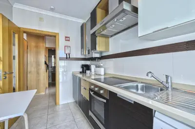 a kitchen with a sink and a counter top at Apartamento Varandas do Mar in Albufeira