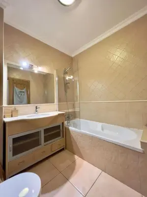 a bathroom with a tub and a sink and a toilet at Vivenda em Vilamoura Marina Ténis Academy in Vilamoura