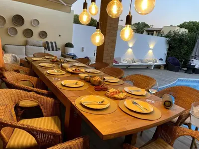 a long wooden table with plates of food on it at Vivenda em Vilamoura Marina Ténis Academy in Vilamoura