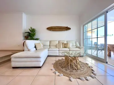 a living room with a white couch and a glass table at Vivenda em Vilamoura Marina Ténis Academy in Vilamoura