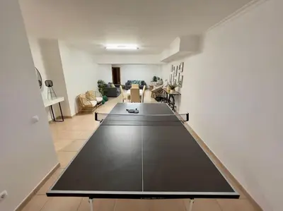 a living room with a large table in the middle at Vivenda em Vilamoura Marina Ténis Academy in Vilamoura