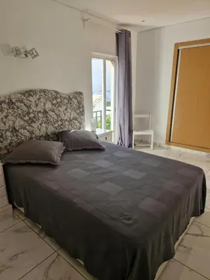 a large bed in a bedroom with a window at Perfect location for nightlife @ the Strip in Albufeira