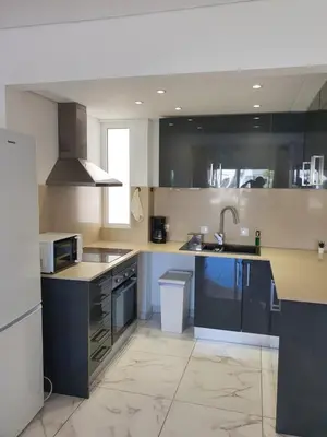 a large kitchen with blue cabinets and a sink at Perfect location for nightlife @ the Strip in Albufeira
