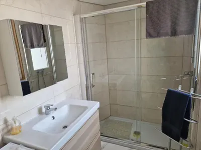 a bathroom with a sink and a shower at Perfect location for nightlife @ the Strip in Albufeira