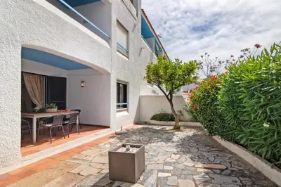 a patio with a table and chairs in a building at Apartment Mar Azul 1 in Albufeira