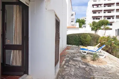 a house with a door and a chair on a patio at Apartment Mar Azul 1 in Albufeira