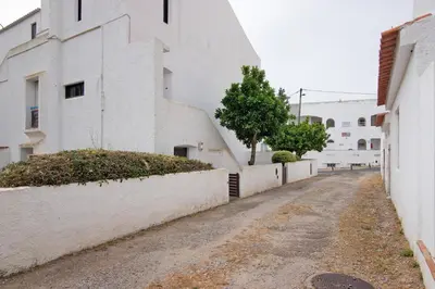 an empty street next to a white building at Apartment Mar Azul 1 in Albufeira