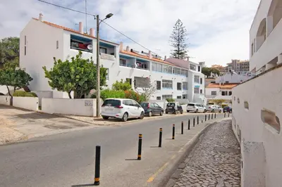 a street with cars parked on the side of the road at Apartment Mar Azul 1 in Albufeira
