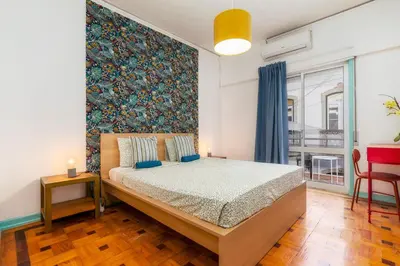 a bedroom with a bed and a large window at Happen!ng 2 in Faro
