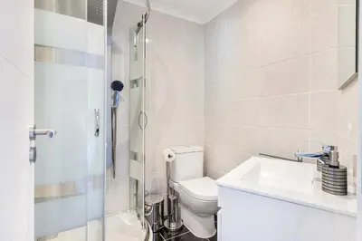 a bathroom with a toilet and a sink and a shower at Ria Mar Deluxe - City Center @Homesbyfc in Faro