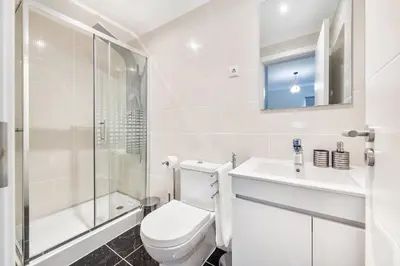 a bathroom with a toilet and a sink and a shower at Ria Mar Deluxe - City Center @Homesbyfc in Faro