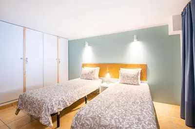 two beds in a hotel room withermottermottermottermott at Stunning terrace with ocean view in Albufeira