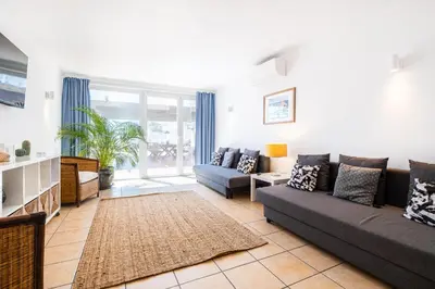 a living room with a couch and a table at Stunning terrace with ocean view in Albufeira