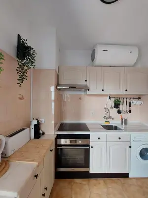 a kitchen with white cabinets and a sink at Coluna Mar in Quarteira