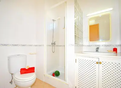 a white bathroom with a toilet and a sink at Villa Isis by Algarve Vacation in Albufeira