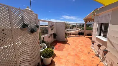 a living room with a couch and chairs and a balcony at Penthouse T2 pool Terrace time in Albufeira