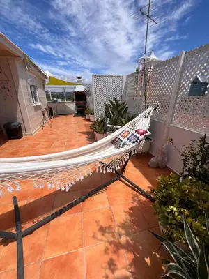 a living room with two chairs and a flat screen tv at Penthouse T2 pool Terrace time in Albufeira
