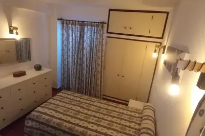 a small bedroom with a bed and a dresser at Bela Vista Algarve in Albufeira