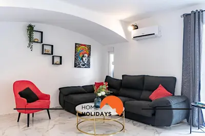 a living room with a black couch and red chairs at #266 Luxurious Villa Bellagio in Albufeira