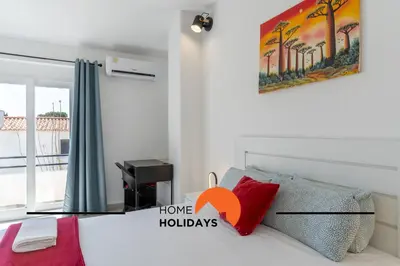 a bedroom with a bed and a painting on the wall at #267 Cozy Villa Casablanca in Albufeira
