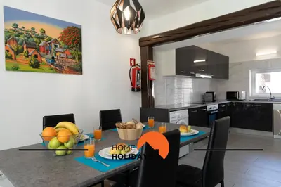 a kitchen with a table with a bowl of fruit on it at #267 Cozy Villa Casablanca in Albufeira