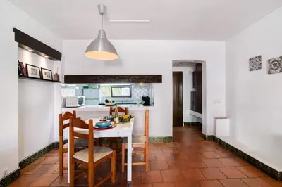 a living room with a fireplace and two chairs at Mar Azul 4 in Albufeira