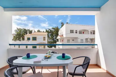 a room with a table and chairs on a balcony at Mar Azul 4 in Albufeira