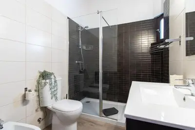 a bathroom with a shower and a toilet and a sink at Casa da Aldeia in Albufeira