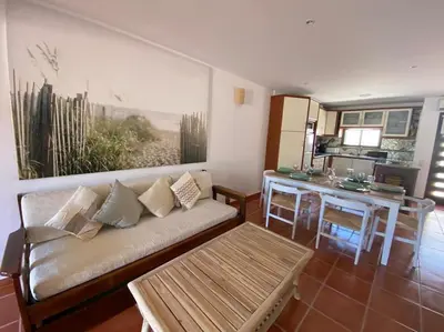 a living room with a couch and a table at Beach Villa Alfamar Praia da Falésia in Albufeira