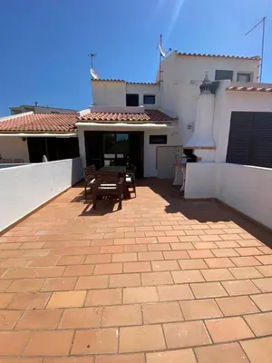 a patio with a table and chairs on a house at Beach Villa Alfamar Praia da Falésia in Albufeira