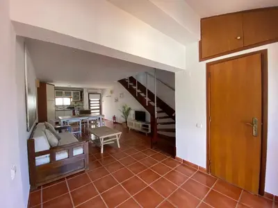 a living room with a couch and a staircase at Beach Villa Alfamar Praia da Falésia in Albufeira