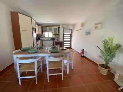 a kitchen and dining room with a table and chairs at Beach Villa Alfamar Praia da Falésia in Albufeira