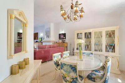 a living room with two red couches and a fireplace at Vila Senna in Vale do Lobo