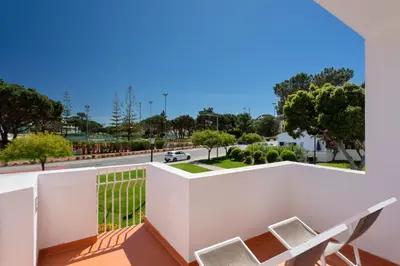 a bedroom with a bed and a sliding glass door at Vila Senna in Vale do Lobo