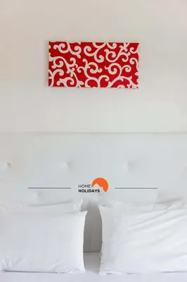 a bed with a red and white picture on the wall at #146 Summer House A6 by Home Holidays in Ferreiras