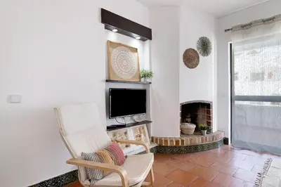 a living room with a tv and a fireplace at Mar azul 3 in Albufeira