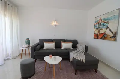 a living room with a couch and a table at São Rafael Beach Apartment 92A, Albufeira - Algarve in Albufeira
