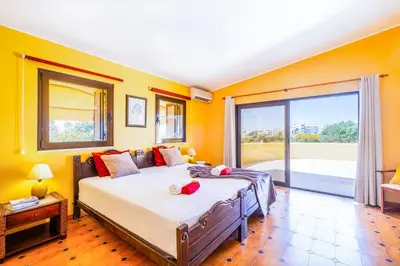 a bedroom with a bed and a large window at Villa Samui by Algarve Vacation in Albufeira