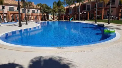 a shadow of a person taking a picture of a swimming pool at Villa Jardins 3 by Sunny Deluxe in Albufeira