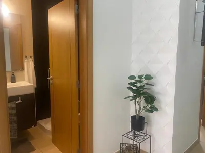 a bathroom with a potted plant sitting next to a door at Villa Jardins 3 by Sunny Deluxe in Albufeira
