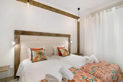 a bedroom with two beds with towels on them at Casa na Travessa 2 in Faro