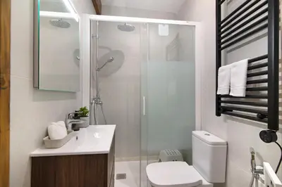 a bathroom with a shower and a toilet and a sink at Casa na Travessa 2 in Faro