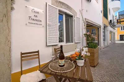 a table with a bottle of wine and a glass at Casa na Travessa 2 in Faro